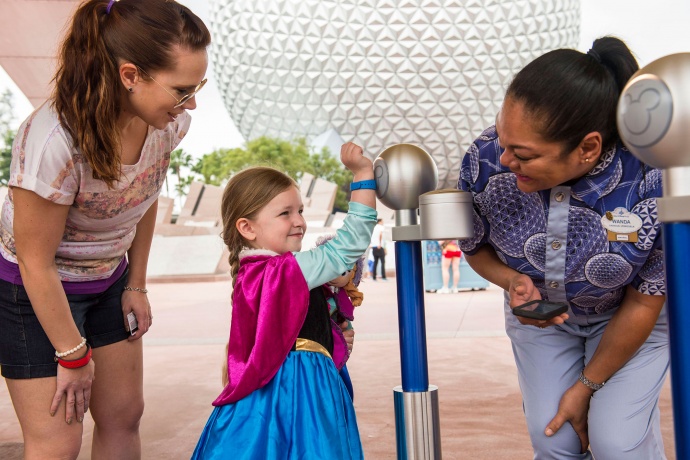 Wearable technology that tracks biometrics data grants girl in Anna costume access to Disney parks and attractions