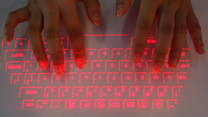 A visitor tries a laser projection keyboard supported by bluetooth technology during the China International software product exposition in Nanjing, east China's Jiangsu province, September 1, 2006. 